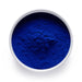 Dolce Superfoods blue spirulina phycocyanin powder in white bowl on white background
