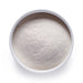 Dolce Superfoods L-theanine powder in white bowl on white background