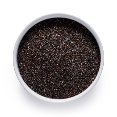 Dolce Superfoods organic chia seeds in white bowl on white background