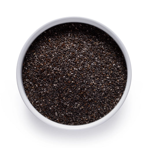 Dolce Superfoods organic chia seeds in white bowl on white background