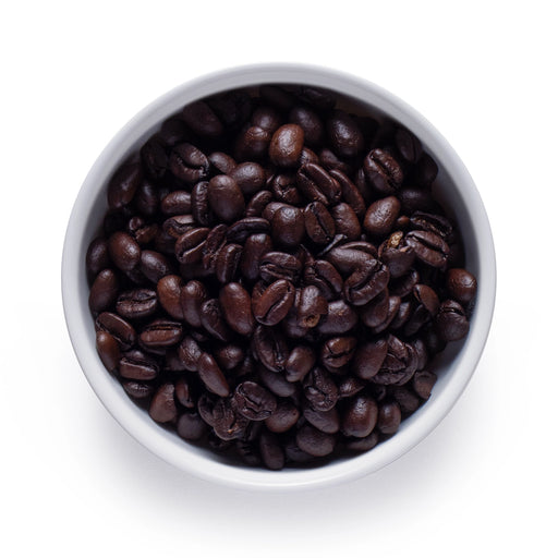 Dolce Superfoods organic dark roast whole bean coffee in white bowl on white background