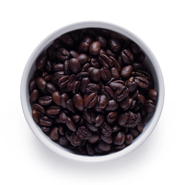 Dolce Superfoods organic dark roast whole bean coffee in white bowl on white background