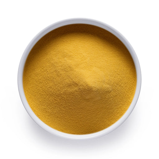 Dolce Superfoods organic mango powder in white bowl on white background