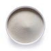 Dolce Superfoods collagen powder in white bowl on white background