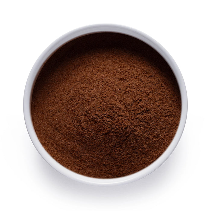 Dolce Superfoods organic Ceylon cinnamon powder in white bowl on white background