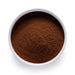 Dolce Superfoods organic Ceylon cinnamon powder in white bowl on white background