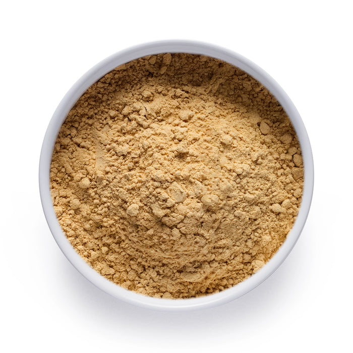 Dolce Superfoods organic ginger powder in white bowl on white background