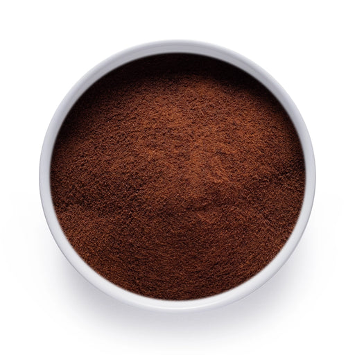 Dolce Superfoods organic instant coffee powder in white bowl on white background