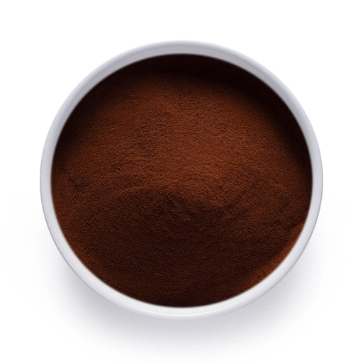 Dolce Superfoods organic instant black tea powder in white bowl on white background