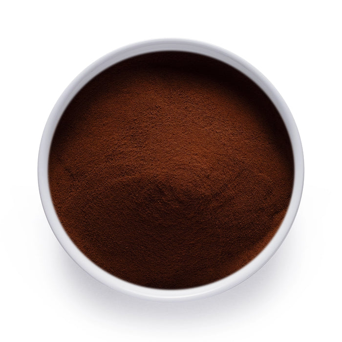 Dolce Superfoods organic instant black tea powder in white bowl on white background