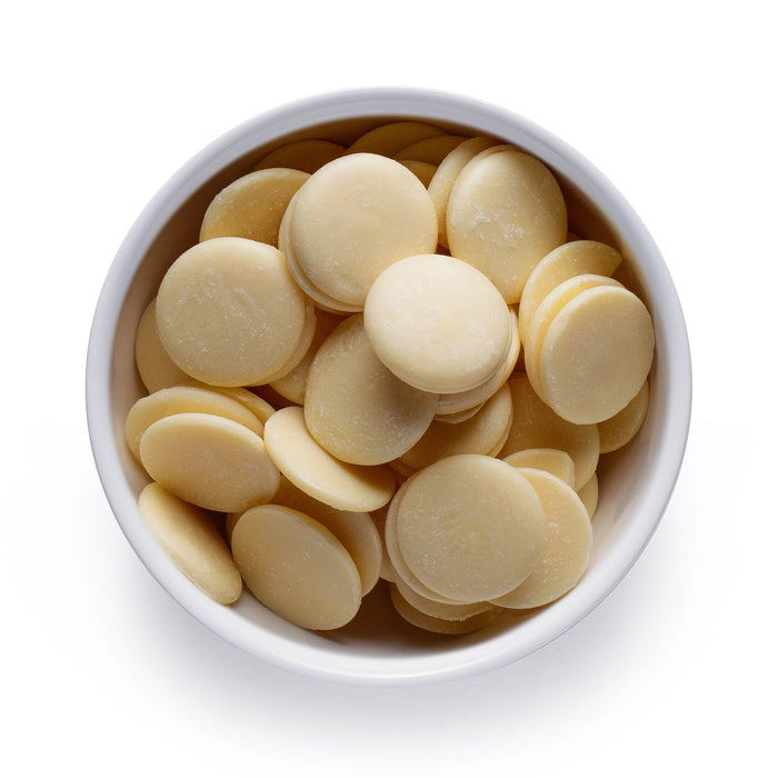 Dolce Superfoods organic cacao butter wafers in white bowl on white background