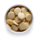 Dolce Superfoods organic cacao butter wafers in white bowl on white background