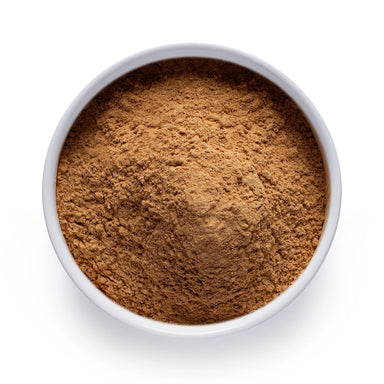 Dolce Superfoods organic black maca powder in white bowl on white background