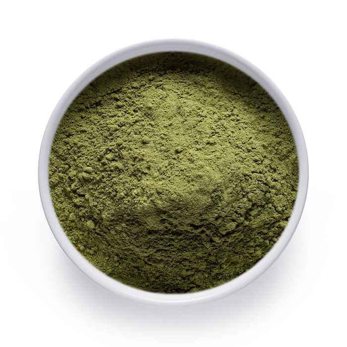 Dolce Superfoods organic moringa leaf powder in white bowl on white background