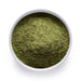 Dolce Superfoods organic moringa leaf powder in white bowl on white background