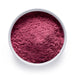 Dolce Superfoods organic red tart cherry powder in white bowl on white background