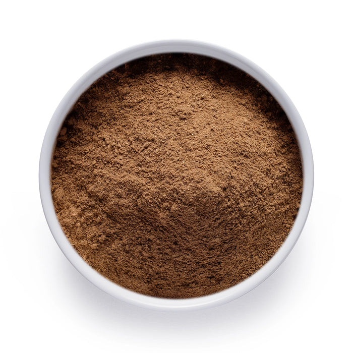 Dolce Superfoods porcini mushroom powder in white bowl on white background