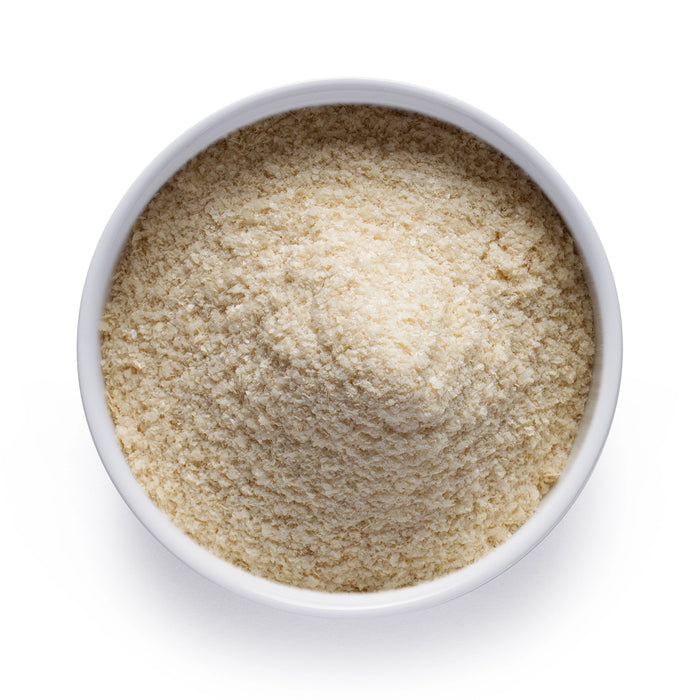 Dolce Superfoods tocotrienols powder in white bowl on white background