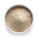 Dolce Superfoods tocotrienols powder in white bowl on white background