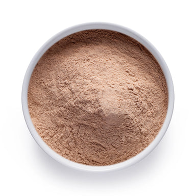 Dolce Superfoods organic lucuma powder in white bowl on white background