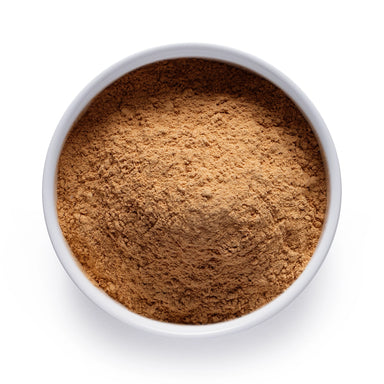 Dolce Superfoods organic maca root powder in white bowl on white background