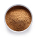 Dolce Superfoods organic maca root powder in white bowl on white background