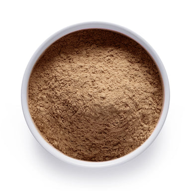 Dolce Superfoods organic maca root powder in white bowl on white background