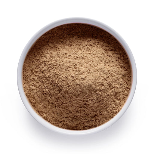 Dolce Superfoods organic maca root powder in white bowl on white background