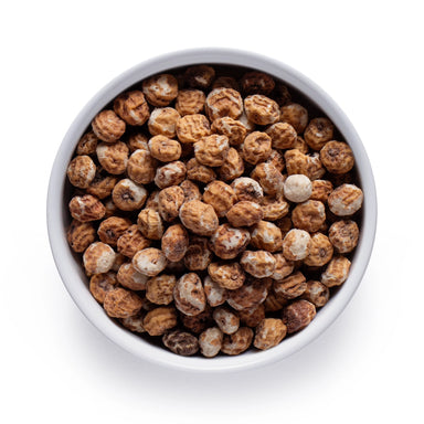 Dolce Superfoods organic peeled tiger nuts in white bowl on white background