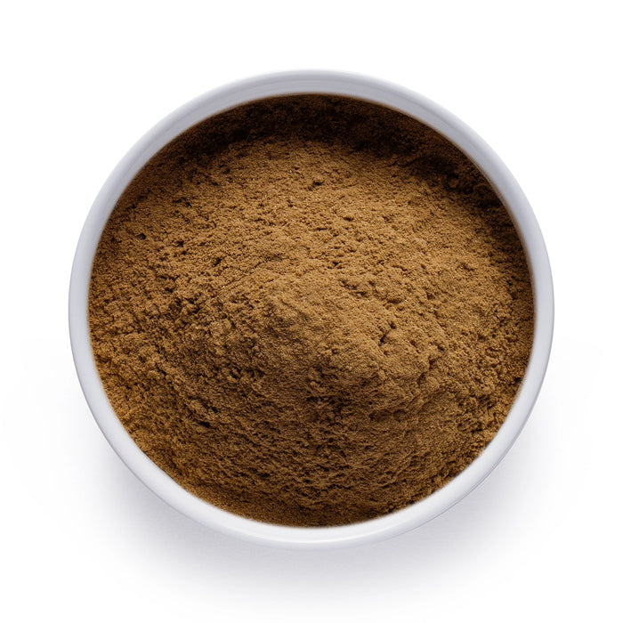 Dolce Superfoods organic wheatgrass powder in white bowl on white background