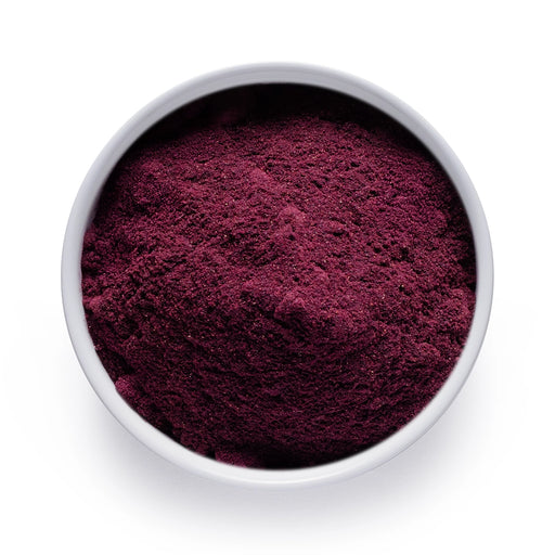 Dolce Superfoods organic blueberry powder in white bowl on white background