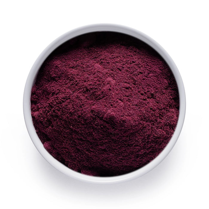Dolce Superfoods organic blueberry powder in white bowl on white background