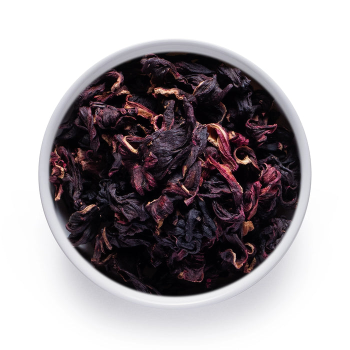 Dolce Superfoods organic dried hibiscus flowers in white bowl on white background