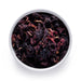 Dolce Superfoods organic dried hibiscus flowers in white bowl on white background