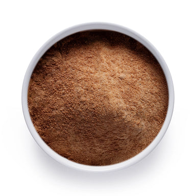 Dolce Superfoods organic coconut sugar in white bowl on white background