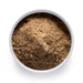 Dolce Superfoods chaga mushroom powder in white bowl on white background