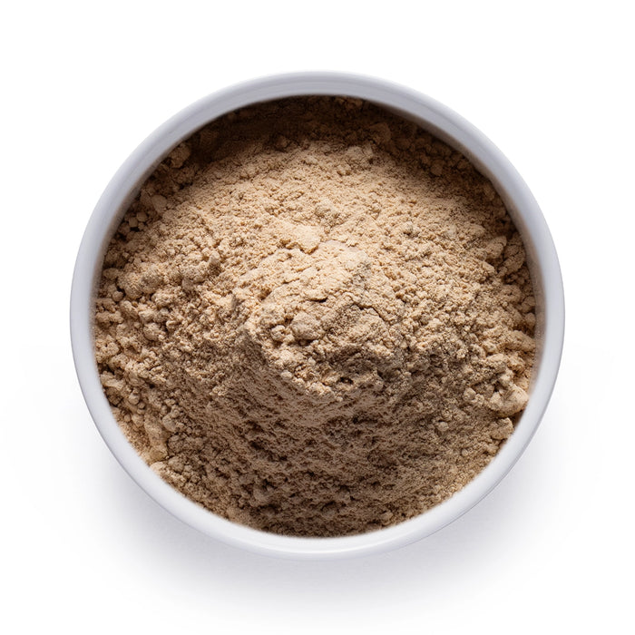 Dolce Superfoods lion’s mane mushroom powder in white bowl on white background