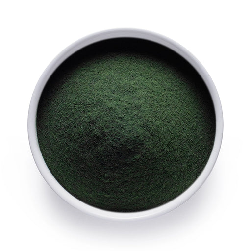 Dolce Superfoods organic chlorella powder in white bowl on white background