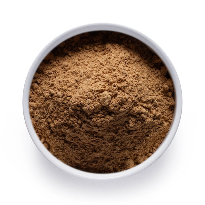 Dolce Superfoods reishi mushroom powder in white bowl on white background