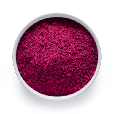Bulk dragon fruit powder in a white bowl, vivid magenta freeze dried pitaya for wholesale superfood blends