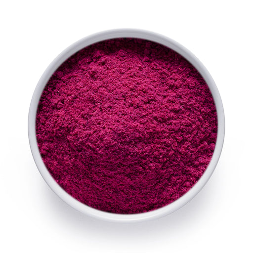 Bulk dragon fruit powder in a white bowl, vivid magenta freeze dried pitaya for wholesale superfood blends