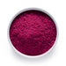 Bulk dragon fruit powder in a white bowl, vivid magenta freeze dried pitaya for wholesale superfood blends