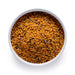 Bulk organic bee pollen in a white bowl, golden multicolor granules sold wholesale by Dolce Superfoods