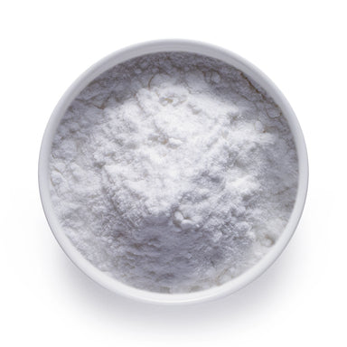 Bulk organic coconut milk powder in a white bowl, fine white dairy-free powder for wholesale beverage and recipe applications.