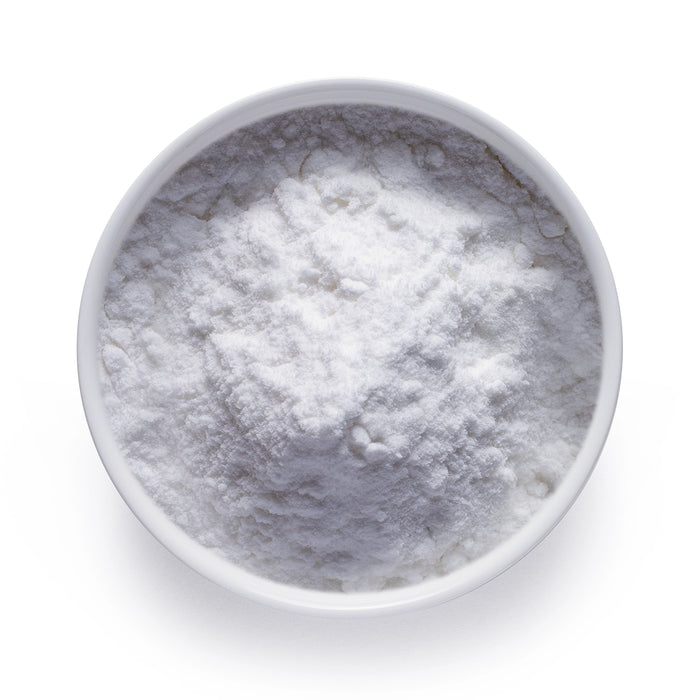 Bulk organic coconut milk powder in a white bowl, fine white dairy-free powder for wholesale beverage and recipe applications.