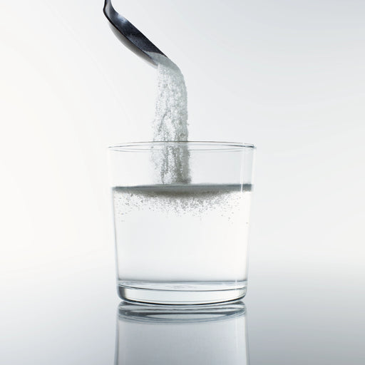 Collagen powder dissolving into glass of water – Dolce Superfoods bulk organic wholesale ingredient