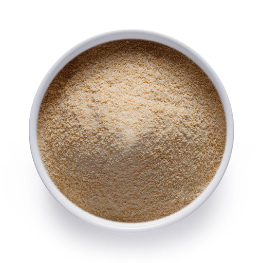 Bulk organic vanilla powder in a white bowl, finely ground vanilla for wholesale baking, beverages, and functional food use.