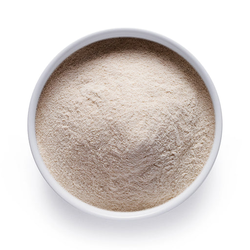 Bulk organic oat milk powder in a white bowl, smooth plant-based milk powder for wholesale beverage and barista applications.