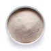 Bulk organic oat milk powder in a white bowl, smooth plant-based milk powder for wholesale beverage and barista applications.