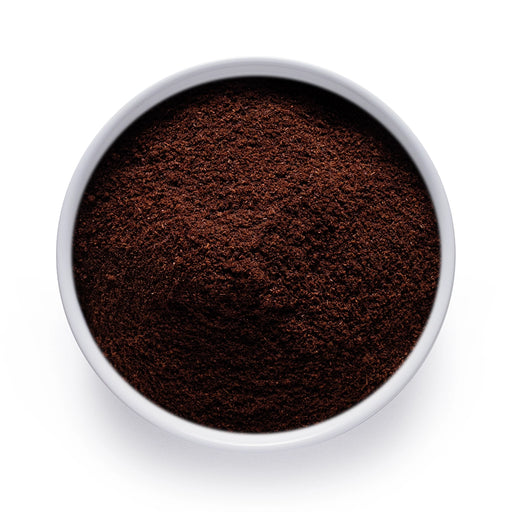 Bulk organic vanilla powder in a white bowl, finely ground vanilla for wholesale baking, beverages, and functional food use.